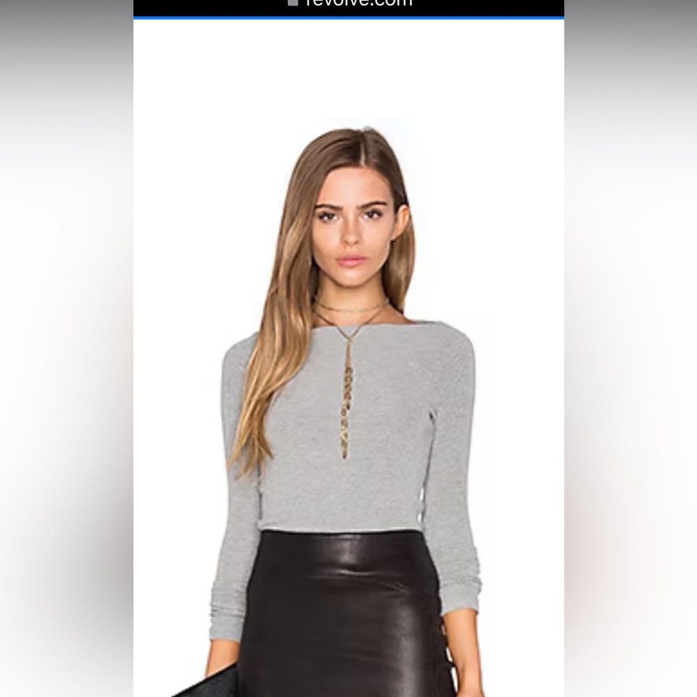 Tight fitting, very long ribbed sweater with boat neck.  Awesome basic piece.